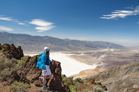 Young female hiker admiring beautiful view of Death Valley from Dante's View viewpoint, California, USA. Exploring the American Southwest.の写真素材