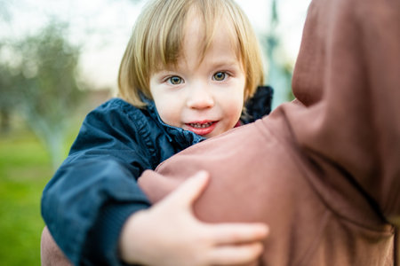 Cute big sister cuddling with her toddler brother. Adorable preteen girl piggybacking her small sibling. Children with large age gap. Siblings getting along.の写真素材