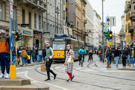 MILAN, ITALY - APRIL 2022: Tourists and locals walking down busy streets in the center of Milan, a metropolis in Italy's northern Lombardy region. Milan, Lombardy, Italy.のeditorial素材