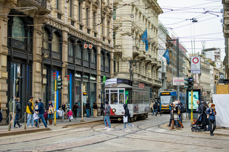 MILAN, ITALY - APRIL 2022: Tourists and locals walking down busy streets in the center of Milan, a metropolis in Italy's northern Lombardy region. Milan, Lombardy, Italy.のeditorial素材