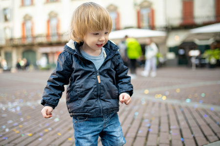 Cute toddler boy walking down the street of Bergamo. Little child having fun exploring in Citta Alta, upper district of Bergamo. Bergamo, Lombardy, Italy.の写真素材