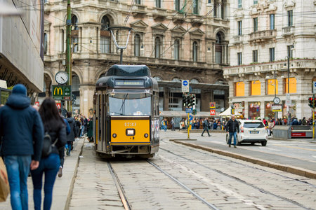MILAN, ITALY - APRIL 2022: Tourists and locals walking down busy streets in the center of Milan, a...