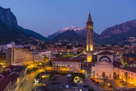 Stunning aerial cityscape of Lecco town on spring evening. Picturesque waterfront of Lecco town located between famous Lake Como and scenic Bergamo Alps mountains. Vacation destination in Italy.の写真素材