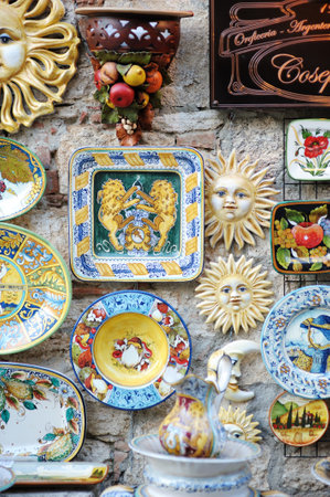 LUCCA, ITALY - MAY 2011: Painted ceramic dishes on a showcase. Typical ceramics sold in beautiful medieval town of Lucca, Italyのeditorial素材