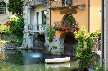 Boat docked near old medieval house in Como town, Lake Como, Italy, Europeの写真素材