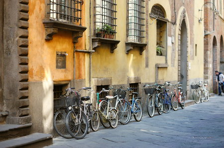 Bicycles parked on beautiful medieval streets of Lucca city, known for its intact Renaissance-era city walls, Tuscany, Italy.の写真素材