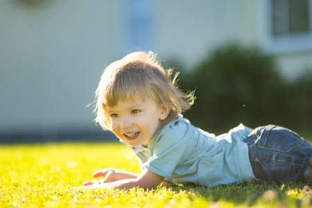 Adorable toddler boy having fun outdoors on sunny summer day. Child exploring nature. Summer activities for small kids.の写真素材