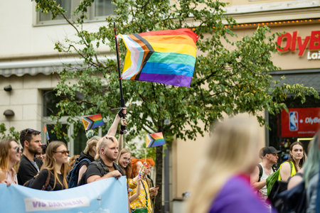 VILNIUS, LITHUANIA - JULY 1, 2023: Happy cheerful people participating in Vilnius Pride 2023 parade, that took place in Vilnius Old Town. Event celebrating lesbian, gay, bisexual, LGBTI culture pride.のeditorial素材