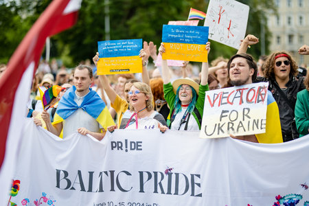 VILNIUS, LITHUANIA - JULY 1, 2023: Happy cheerful people participating in Vilnius Pride 2023 parade, that took place in Vilnius Old Town. Event celebrating lesbian, gay, bisexual, LGBTI culture pride.のeditorial素材
