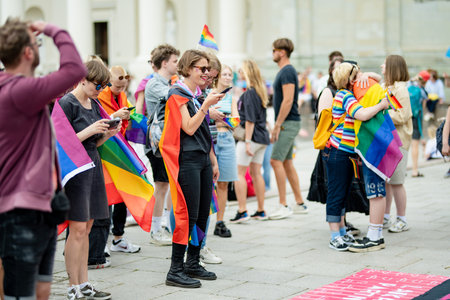 VILNIUS, LITHUANIA - JULY 1, 2023: Happy cheerful people participating in Vilnius Pride 2023 parade,...