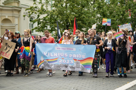 VILNIUS, LITHUANIA - JULY 1, 2023: Happy cheerful people participating in Vilnius Pride 2023 parade, that took place in Vilnius Old Town. Event celebrating lesbian, gay, bisexual, LGBTI culture pride.のeditorial素材