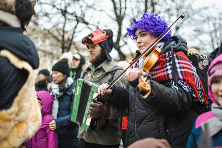 VILNIUS, LITHUANIA - FEBRUARY 21, 2023: Hundreds of people celebrating Uzgavenes, a Lithuanian annual folk festival taking place before Easter. Participants wearing traditional masks and costumes.のeditorial素材