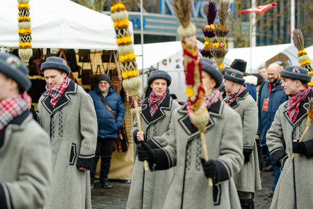 VILNIUS, LITHUANIA - MARCH 4, 2023: Cheerful people participating in humorous parade during Kaziuko muge or Kaziukas, traditional Easter market, crafts fair held every March on Old Town streets.のeditorial素材