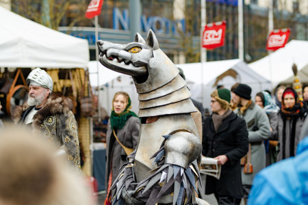 VILNIUS, LITHUANIA - MARCH 4, 2023: Cheerful people participating in humorous parade during Kaziuko muge or Kaziukas, traditional Easter market, crafts fair held every March on Old Town streets.のeditorial素材