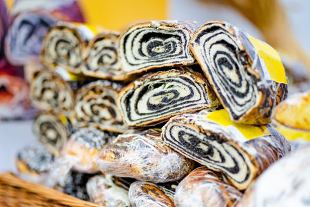 Simtalapis, traditional Lithuanian cake made of yeast dough and poppy seeds, for sale at outdoor farmers market in Vilnius. Traditional spring fair in Vilnius, the capital of Lithuania.の写真素材