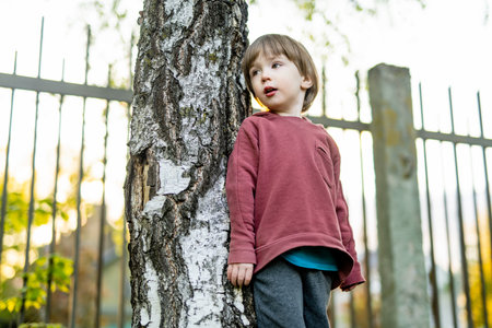 Adorable toddler boy having fun outdoors on sunny summer day. Child exploring nature. Summer...