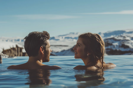 Young couple enjoying spa in hot springs in Iceland. Beautiful woman and man having fun in thermal bath on a backdrop of scenic Icelandic nature. Generative AI.の素材