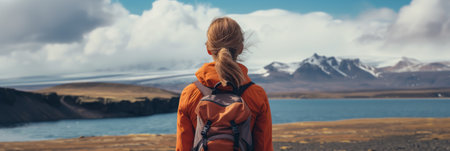 Young female hiker with a backpack admiring scenic view of spectacular Icelandic nature on a sunset. Breathtaking landscape of Iceland. Hiking by foot. Generative AI.の素材