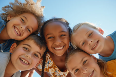 Portrait of cheerful multiracial kids looking into camera and smiling. Children of different skin color, view from below. Generative AI.の素材