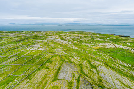 Aerial view of Inishmore or Inis Mor, the largest of the Aran Islands in Galway Bay, Ireland. Famous for its strong Irish culture, loyalty to the Irish language, and a wealth of ancient sites.の写真素材
