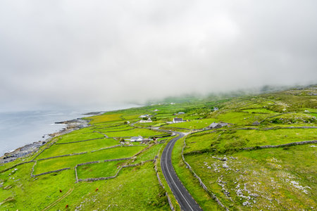 Spectacular misty aerial landscape in the Burren region of County Clare, Ireland. Exposed karst limestone bedrock at the Burren National Park. Rough Irish nature.の写真素材