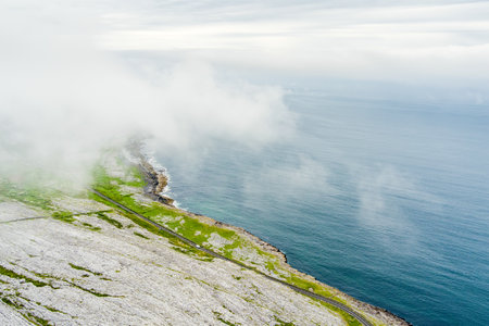 Spectacular misty aerial landscape in the Burren region of County Clare, Ireland. Exposed karst limestone bedrock at the Burren National Park. Rough Irish nature.の写真素材