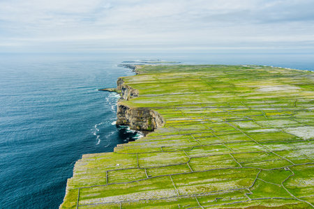 Aerial view of Inishmore or Inis Mor, the largest of the Aran Islands in Galway Bay, Ireland. Famous for its strong Irish culture, loyalty to the Irish language, and a wealth of ancient sites.の写真素材