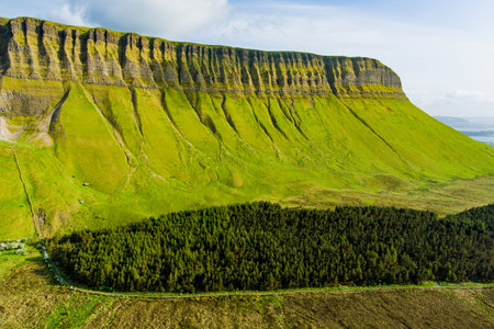 Aerial view of Benbulbin, aka Benbulben or Ben Bulben, iconic landmark, large flat-topped nunatak rock formation. Magnificent costal driving route view at Wild Atlantic Way, County Sligo, Ireland.の写真素材