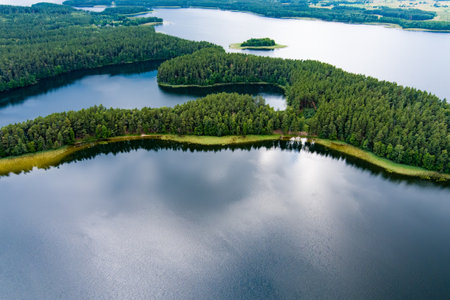 Scenic aerial view of Sciuro Ragas peninsula, separating White Lakajai and Black Lakajai lakes. Picturesque landscape of lakes and forests of Labanoras Regional Park. Natural beauty of Lithuania.の写真素材