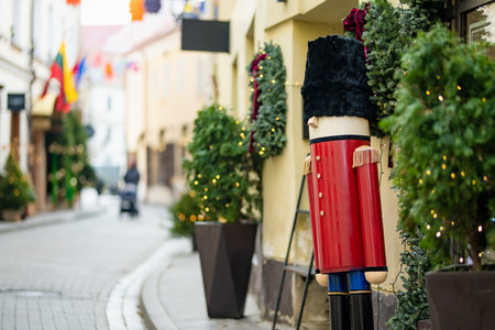Christmas lights, trees and ornaments used as decorations at Festive season. Narrow streets of...