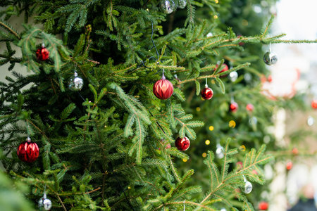 Christmas lights, trees and ornaments used as decorations at Festive season. Narrow streets of...