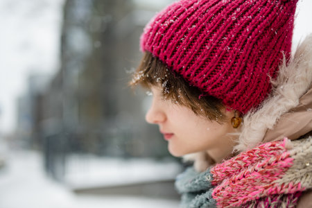 Adorable teenage girl having fun on winter day. Cute child playing in a snow. Fun winter activities...