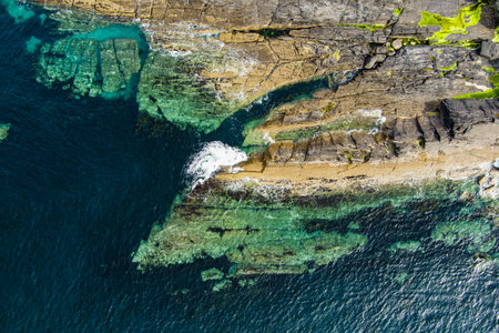Aerial view of rough and rocky shore along famous Ring of Kerry route. Rugged coast of on Iveragh...