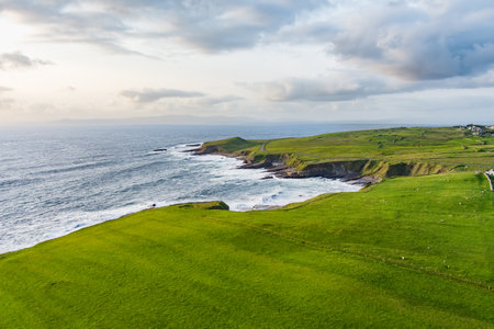 Spectacular aerial view of Mullaghmore Head with huge waves rolling ashore. Picturesque scenery with green pastures and meadows. Signature point of the Wild Atlantic Way, County Sligo, Irelandの写真素材