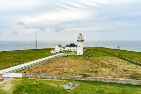 Aerial view of the Loop Head Lighthouse, located south-east of Kilkee, on the northern Dingle Peninsula, on the cliffs of Loop Head in County Clare, Ireland.の写真素材