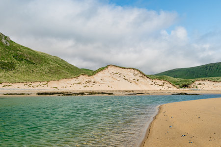 Five Finger Strand, one of the most famous beaches in Inishowen known for its pristine sand and surrounding rocky coastline with some of the highest sand dunes in Europe, county Donegal, Ireland.の写真素材