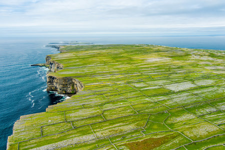 Aerial view of Inishmore or Inis Mor, the largest of the Aran Islands in Galway Bay, Ireland. Famous for its strong Irish culture, loyalty to the Irish language, and a wealth of ancient sites.の写真素材
