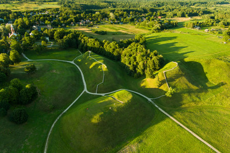 Aerial view of Kernave Archaeological site, a medieval capital of the Grand Duchy of Lithuania, tourist attraction and UNESCO World Heritage Site. Sunny summer evening.の写真素材
