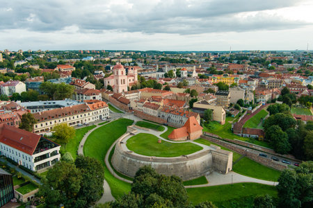 An aerial view of the historic Barbakanas fortification surrounded by the vibrant old town of Vilnius, Lithuania, with its charming rooftops and colorful architecture.の写真素材