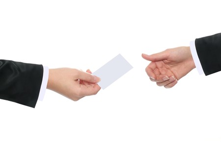 Businesswoman handing out her business card to a businesswomanの写真素材