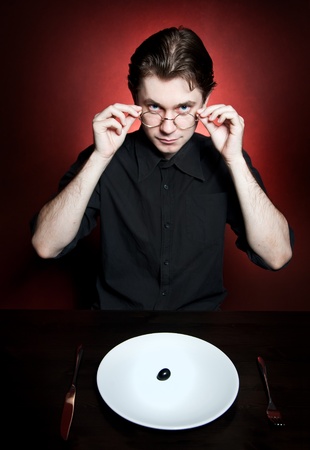 Smart young man eating の写真素材