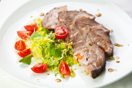 Sliced meat with fresh vegetables の写真素材