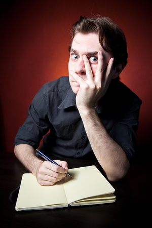 In Search Of Inspiration. A man with an empty notebook.の写真素材