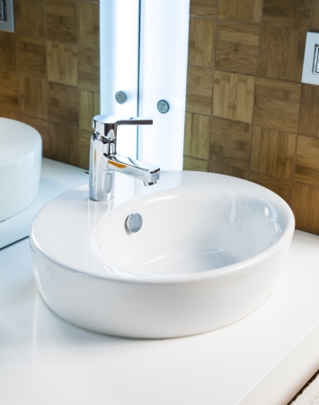 Modern bathroom sink in white ceramic の写真素材