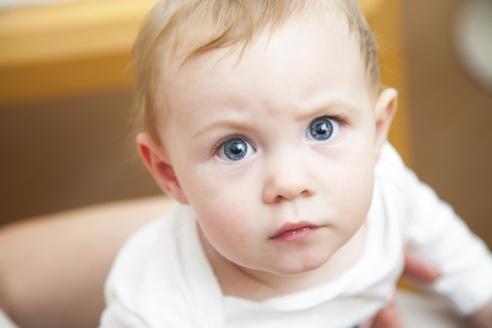 Cute little baby girl with big blue eyesの写真素材