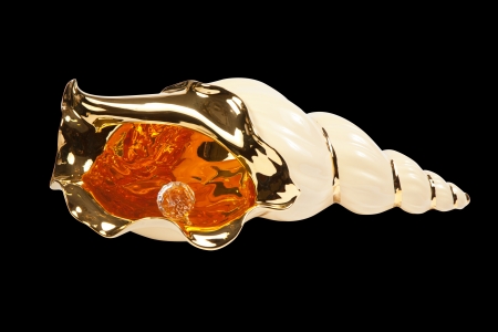 Artificial sea shell with pearl isolated on black background の写真素材