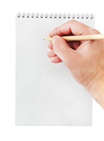 Pencil in hand writing on the notebook, isolated on whiteの写真素材