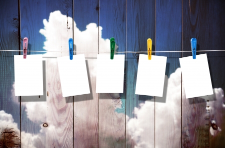 Blank picture frame hanging on clothesline on wood backgroundの写真素材
