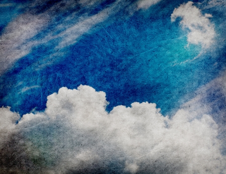 Retro style cloudscape with vintage colors and a textured paper background. の写真素材