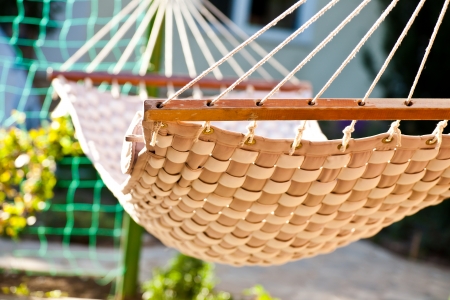 Hammock hanging in the sunny yard, close up photo の写真素材